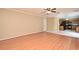 Open living room with wood floors and a view into the kitchen area at 115 Bristol Forest Trl, Sanford, FL 32771