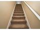 Carpeted stairway with white banister and neutral colored walls at 115 Bristol Forest Trl, Sanford, FL 32771