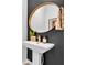 Stylish powder room with designer mirror, modern pedestal sink, and striking accent wall at 11574 Buoy Point Pl, Orlando, FL 32832