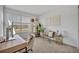 Bright bedroom with large window, modern desk, chair, and decor, perfect for a work-from-home space at 11574 Buoy Point Pl, Orlando, FL 32832