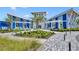 Blue and white community center featuring a well-manicured landscape and outdoor seating areas at 11574 Buoy Point Pl, Orlando, FL 32832