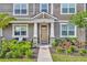 Inviting front entrance with stone accents, beige door, and lush landscaping that creates a warm and welcoming curb appeal at 11574 Buoy Point Pl, Orlando, FL 32832