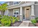 Inviting front porch featuring stone columns, cozy seating, and well-maintained landscaping for relaxing and enjoying the outdoors at 11574 Buoy Point Pl, Orlando, FL 32832