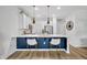 Modern kitchen with white cabinets, stainless steel appliances, a blue accent wall, and pendant lighting at 11574 Buoy Point Pl, Orlando, FL 32832
