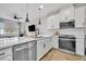 Beautiful kitchen with stainless steel appliances, an island, and an open floor plan into the living room at 11574 Buoy Point Pl, Orlando, FL 32832