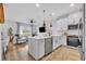 Open concept kitchen featuring stainless steel appliances, quartz counters, and views into the living room at 11574 Buoy Point Pl, Orlando, FL 32832