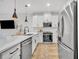 Well-equipped kitchen featuring stainless steel appliances, white cabinets, and quartz countertops at 11574 Buoy Point Pl, Orlando, FL 32832