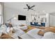 Open-concept living area with contemporary design, featuring a spacious couch, kitchen island, and modern finishes at 11574 Buoy Point Pl, Orlando, FL 32832