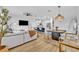 Bright open-concept living area features a kitchen island, dining area, and comfortable seating, creating a welcoming atmosphere at 11574 Buoy Point Pl, Orlando, FL 32832