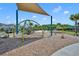 A modern playground features climbing structures, covered areas, and ample space for to play and explore at 11574 Buoy Point Pl, Orlando, FL 32832
