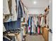 Spacious walk-in closet with custom shelving and ample storage for clothes, shoes, and accessories at 11574 Buoy Point Pl, Orlando, FL 32832