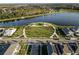 An aerial view showcases a lake and a central park with walking paths, palms, and an open-air picnic area at 11631 Mystery Ln, Orlando, FL 32832