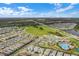 Aerial view of a Primary-planned community with beautiful homes, green spaces, resort-style pool, and playground at 11631 Mystery Ln, Orlando, FL 32832