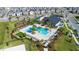 This aerial view showcases the community pool, clubhouse, playground, and the beautiful surrounding landscape at 11631 Mystery Ln, Orlando, FL 32832