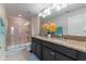 Bathroom featuring double sinks, granite countertops, and a glass-enclosed shower at 11631 Mystery Ln, Orlando, FL 32832