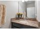 Bright bathroom featuring granite vanity, chrome faucet, decorative towels, and fresh flowers at 11631 Mystery Ln, Orlando, FL 32832