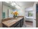 Stylish bathroom features double sinks with granite countertops and vanity lighting at 11631 Mystery Ln, Orlando, FL 32832