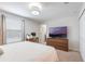 Bright bedroom featuring a large window, a spacious closet, and a dedicated workspace at 11631 Mystery Ln, Orlando, FL 32832