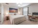 Bright bedroom has a desk and sunset picture on the wall at 11631 Mystery Ln, Orlando, FL 32832