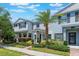 Charming townhouse with a well-manicured lawn, walkway, and attractive landscaping on a sunny day at 11631 Mystery Ln, Orlando, FL 32832
