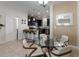 Modern kitchen open to the dining area, featuring dark cabinetry and stainless-steel appliances at 11631 Mystery Ln, Orlando, FL 32832