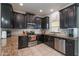 Well-equipped kitchen featuring sleek, dark cabinetry and stainless-steel appliances at 11631 Mystery Ln, Orlando, FL 32832