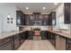 Well-equipped kitchen featuring sleek, dark cabinetry and stainless-steel appliances at 11631 Mystery Ln, Orlando, FL 32832