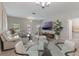 Comfortable living room with white sofa, glass table, TV and stairway to the second floor at 11631 Mystery Ln, Orlando, FL 32832