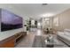 Inviting living room boasts tile floors, a large screen tv, and an open floor plan to the dining and kitchen areas at 11631 Mystery Ln, Orlando, FL 32832