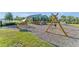 An outdoor playground includes a swing set, slides, climbing structures, and benches in a park-like setting at 11631 Mystery Ln, Orlando, FL 32832