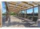 Lounge poolside under a shaded pergola while enjoying scenic views of lush landscaping, the pool, and tennis court at 11631 Mystery Ln, Orlando, FL 32832