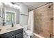 A well-lit bathroom features a tile shower and updated vanity at 124 Mcleods Way, Winter Springs, FL 32708