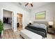 A stylish bedroom with a luxurious bed, bench, and ensuite bathroom and closet at 124 Mcleods Way, Winter Springs, FL 32708