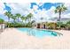 A sparkling community pool with palm trees, a beach entry, and lounge chairs creates a relaxing oasis at 124 Mcleods Way, Winter Springs, FL 32708