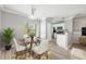 Dining area with a round table, white chairs, and adjacent modern kitchen at 124 Mcleods Way, Winter Springs, FL 32708