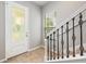A bright entryway featuring a decorative door and staircase at 124 Mcleods Way, Winter Springs, FL 32708