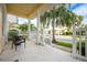 Inviting front porch with classic white columns and room to relax in a tropical setting at 124 Mcleods Way, Winter Springs, FL 32708