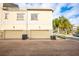 Exterior of the townhome featuring a two-car garage, brick driveway, and central A/C at 124 Mcleods Way, Winter Springs, FL 32708