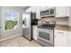 Kitchen featuring stainless steel appliances, light cabinets, and tile flooring at 124 Mcleods Way, Winter Springs, FL 32708