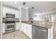 Modern kitchen with stainless steel appliances, granite countertops, and white cabinetry at 124 Mcleods Way, Winter Springs, FL 32708