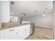 Well-lit kitchen featuring stainless steel appliances, granite countertops, and white cabinets at 124 Mcleods Way, Winter Springs, FL 32708