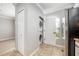 A well-lit laundry room with a stackable washer and dryer unit and convenient storage space at 124 Mcleods Way, Winter Springs, FL 32708