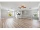 Open-concept living area with wood floors, neutral paint, and a ceiling fan at 124 Mcleods Way, Winter Springs, FL 32708