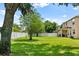 Large grassy backyard with a white vinyl fence, offering privacy and space for outdoor enjoyment at 12917 Grovehurst Ave, Winter Garden, FL 34787
