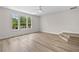 Light-filled bedroom with hardwood floors, a modern ceiling fan, and abundant natural light at 12917 Grovehurst Ave, Winter Garden, FL 34787