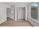 Bedroom featuring closet, wood floors, white walls and trim, and a bright window at 12917 Grovehurst Ave, Winter Garden, FL 34787