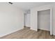Bedroom with closet, wood floors, white walls and trim, and two white doors at 12917 Grovehurst Ave, Winter Garden, FL 34787