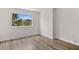 Cozy bedroom featuring a large window, neutral paint, and hardwood flooring at 12917 Grovehurst Ave, Winter Garden, FL 34787
