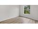 The bedroom has wood floors, white walls and trim, and a bright window at 12917 Grovehurst Ave, Winter Garden, FL 34787