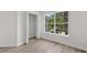 Bedroom with closet, wood floors, white walls and trim, and a bright window at 12917 Grovehurst Ave, Winter Garden, FL 34787